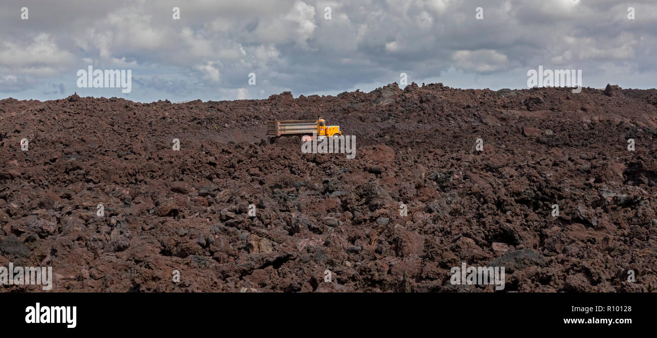 Pahoa, Hawaii Trucks traverse a road being built on cooled lava from the 2018 eruption of the