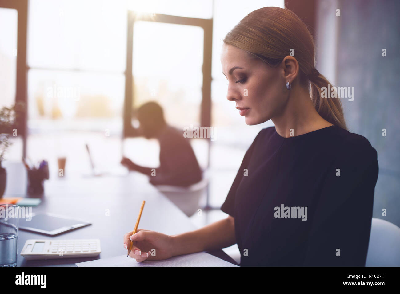 Businesswoman at the office working with a laptop with his team Stock Photo