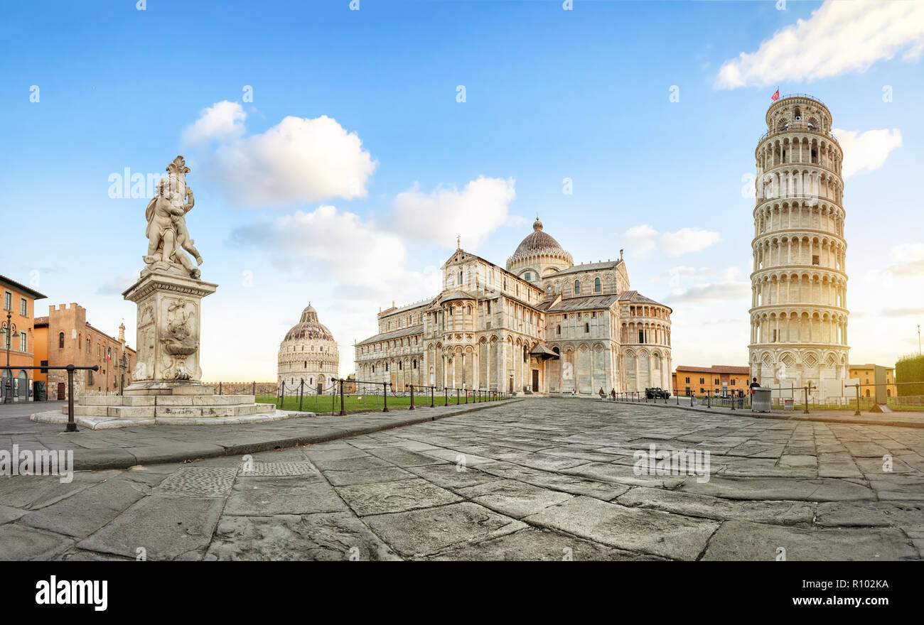 Pisa, Italy. Panoramic low angle view of Piazza del Duomo square with Leaning Tower, Pisa Cathedral and Putti Fountain Stock Photo