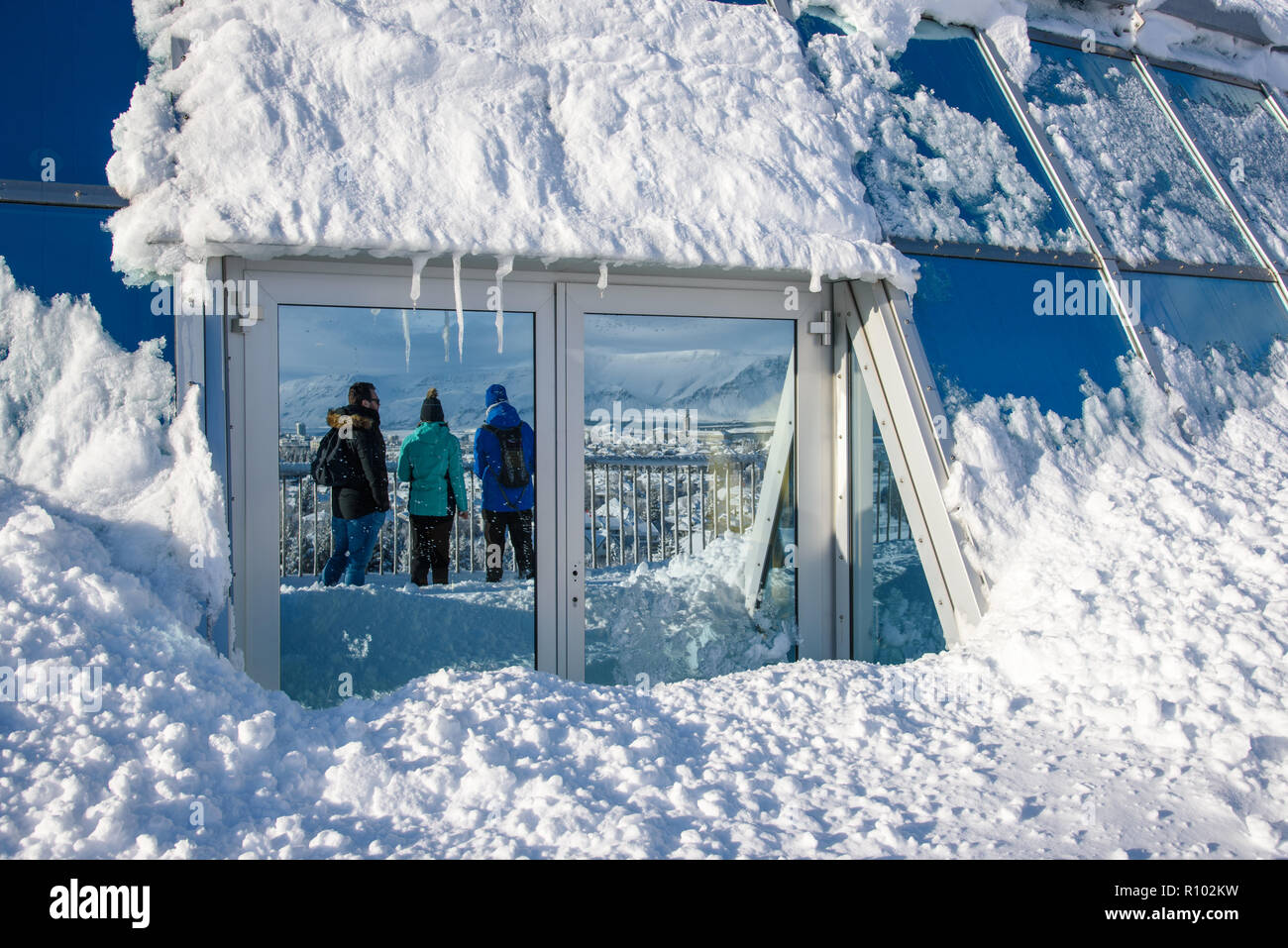 Amazing Iceland in winter - breathtaking scenery and frozen landscapes -  reflection of young people overlooking the white city of Reykjavik Stock  Photo - Alamy
