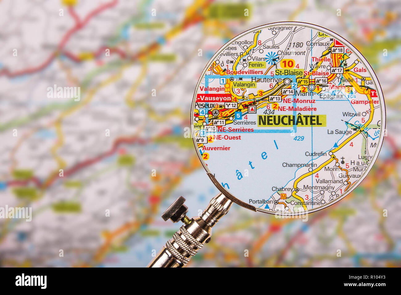 Map of Neuchatel with magnifying glass on table Stock Photo