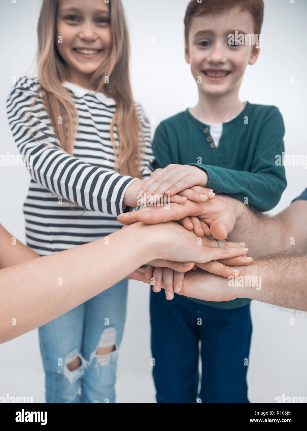 brother and sister joining their hands with their parents Stock Photo