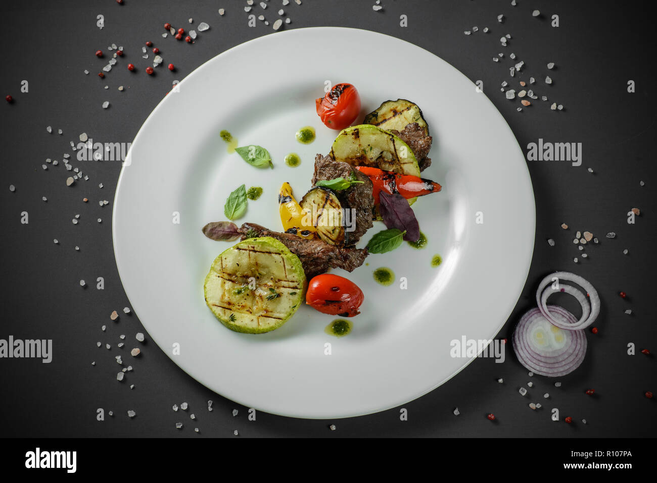 Grilled vegetables with meat decorated on dark background Stock Photo