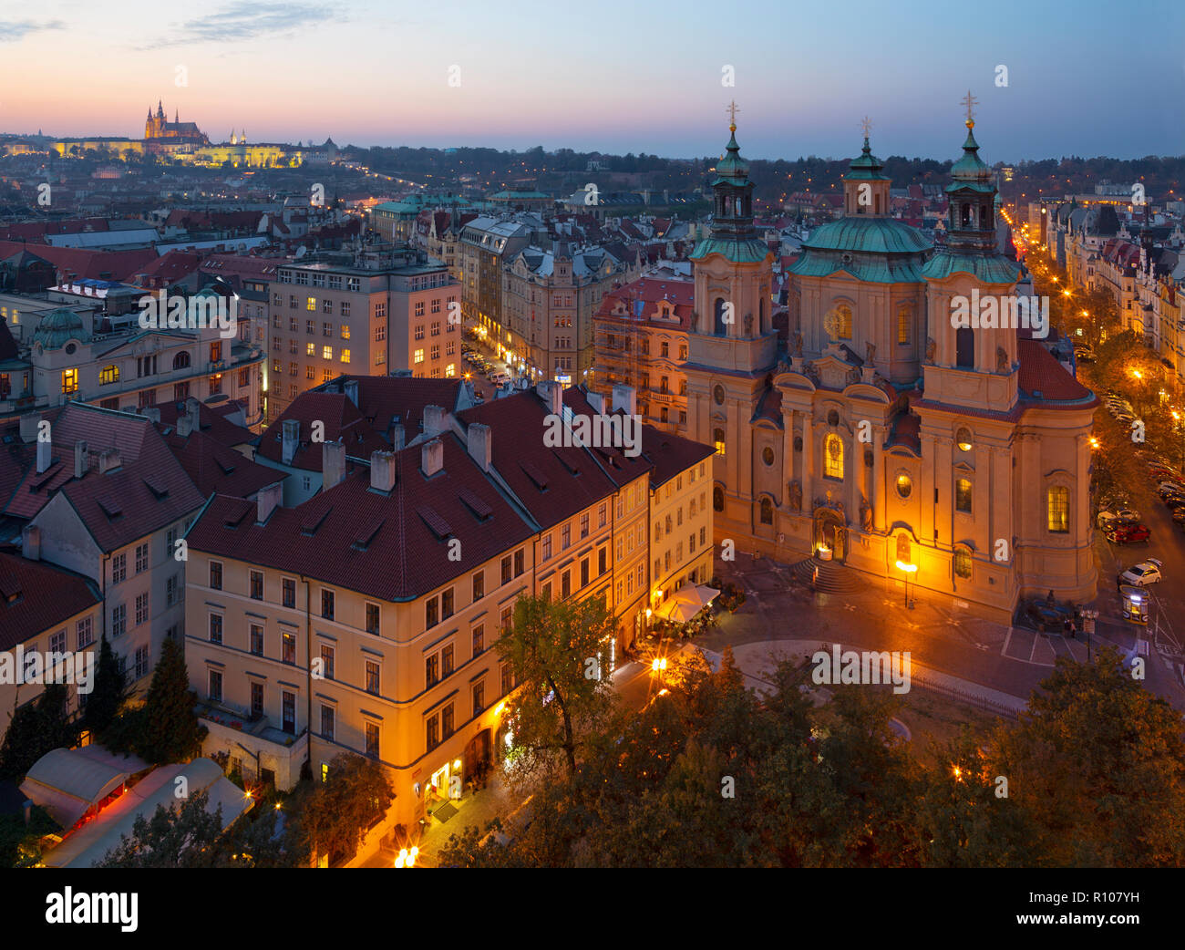 Prague - The St. Nicholas church, Staromestske square and Old Town at dusk. Stock Photo