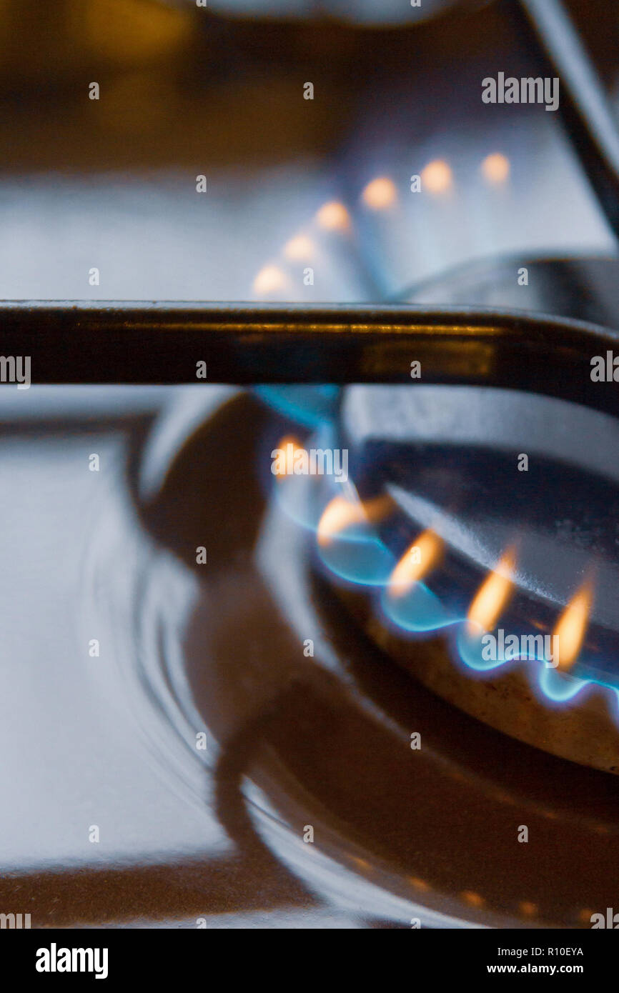 Gas stove with burning orange and blue fire on it Stock Photo Alamy