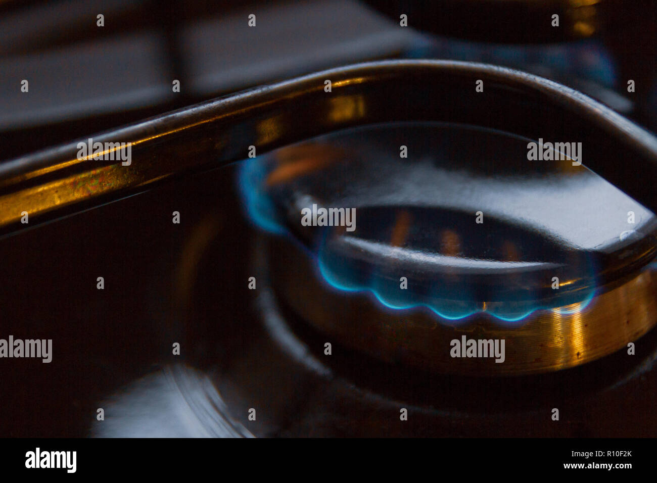 Gas stove with burning orange and blue fire on it Stock Photo Alamy