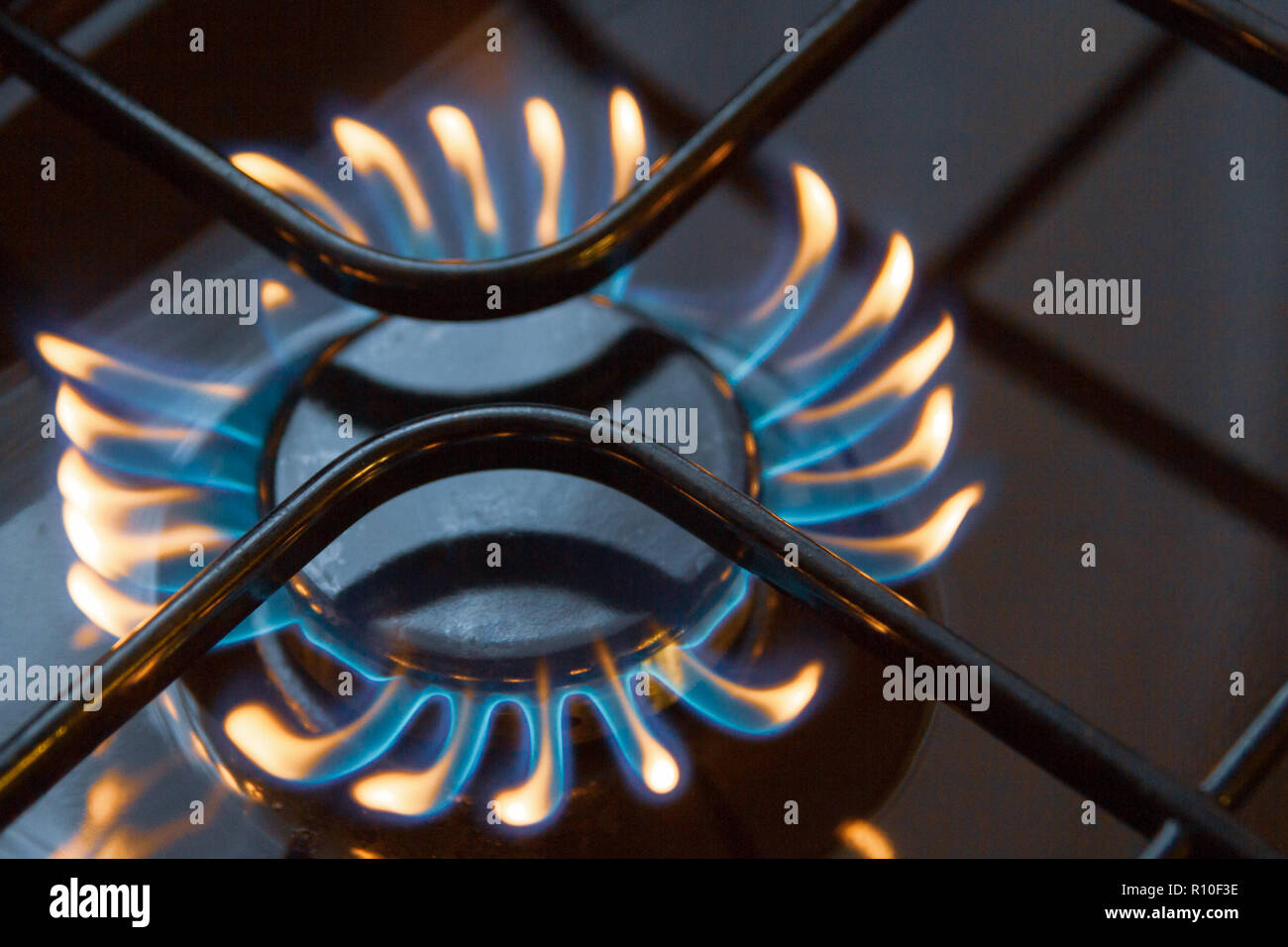 Gas stove with burning orange and blue fire on it Stock Photo Alamy