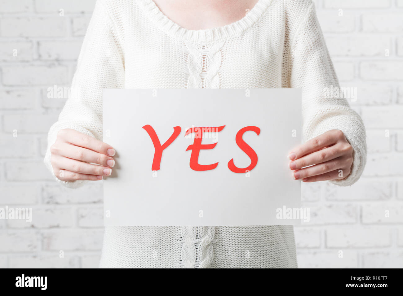 Hand holding card with red word of 'Yes' Stock Photo