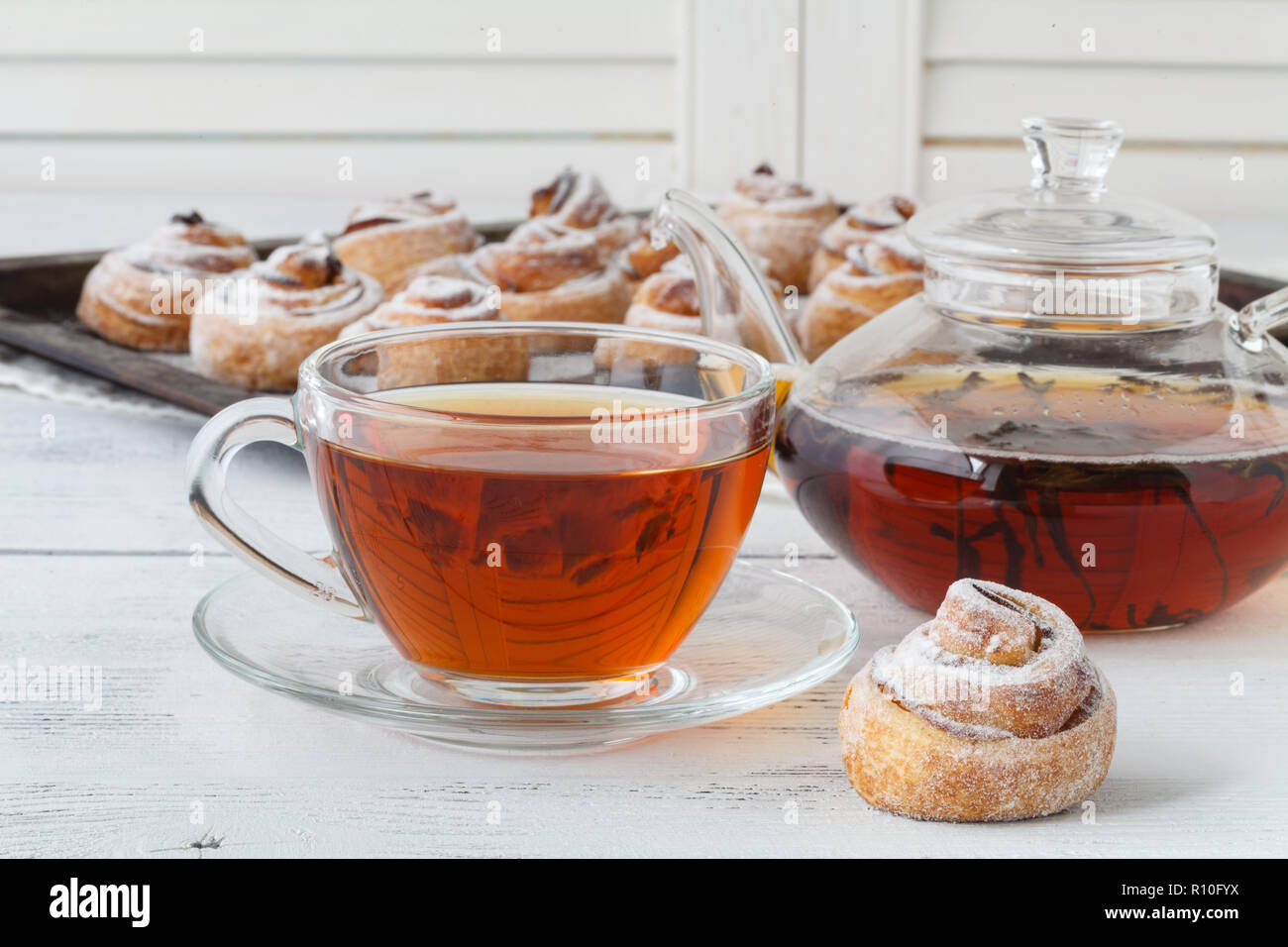 Cup of tea and small apple roses shaped pies. Sweet apple dessert pie ...