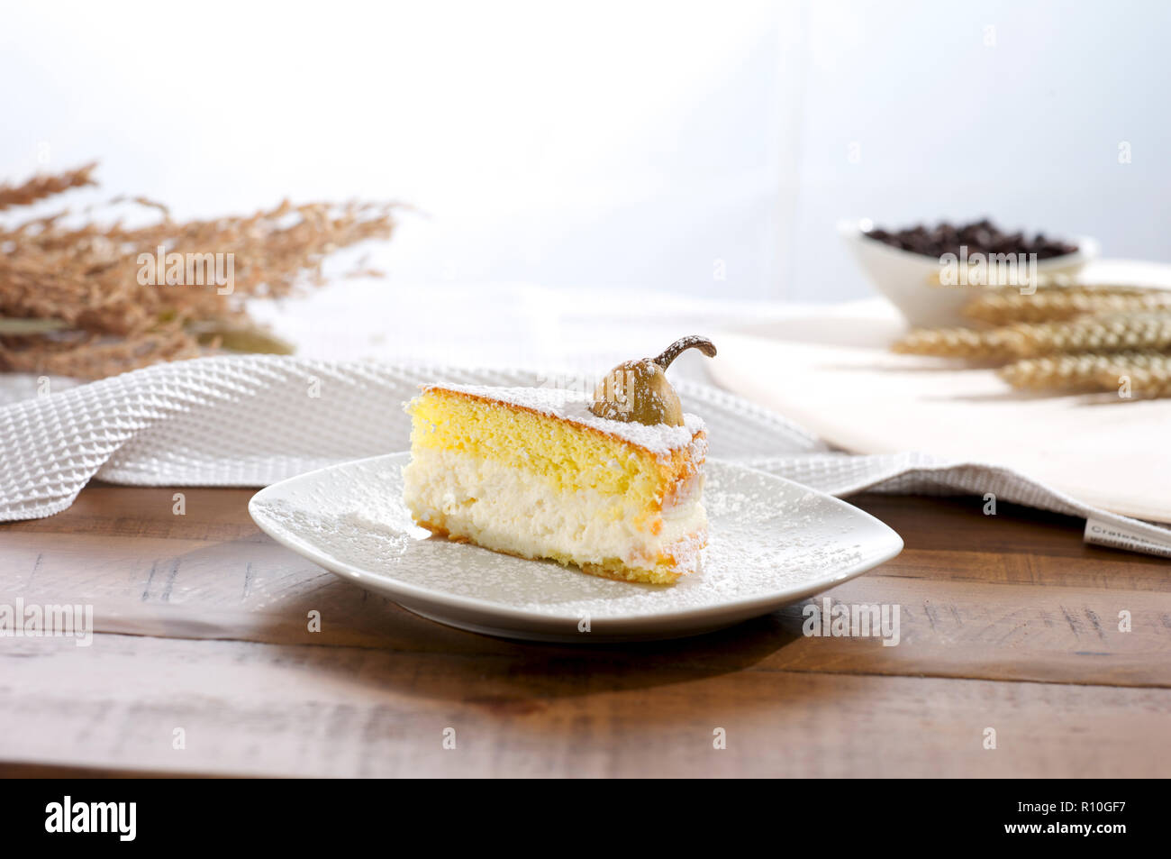 Slice of cake with cream on wooden table, for harvest, space for copy Stock Photo