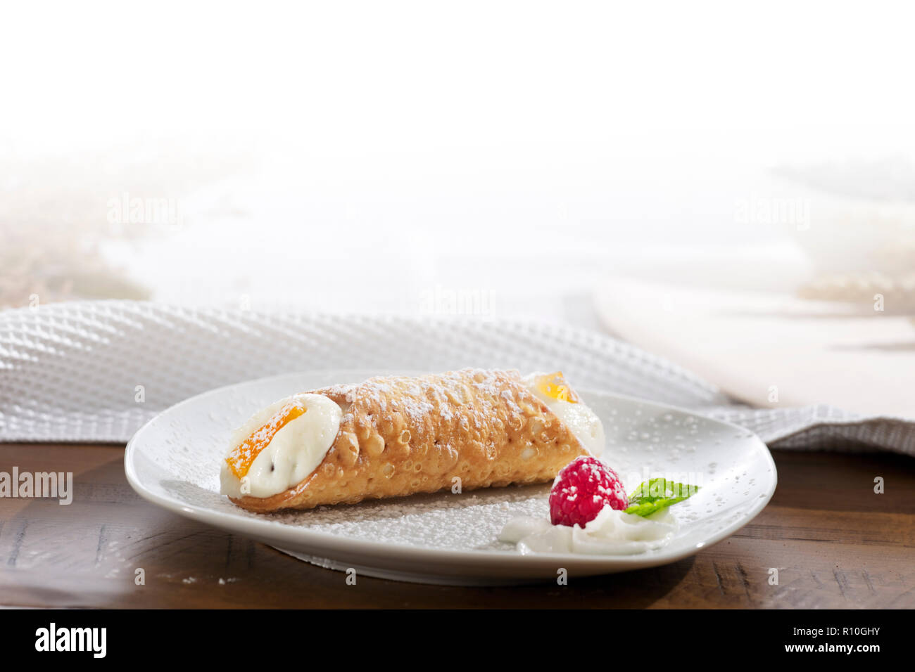 Close up plate of Cannoli on table with white tablecloth, space for copy Stock Photo