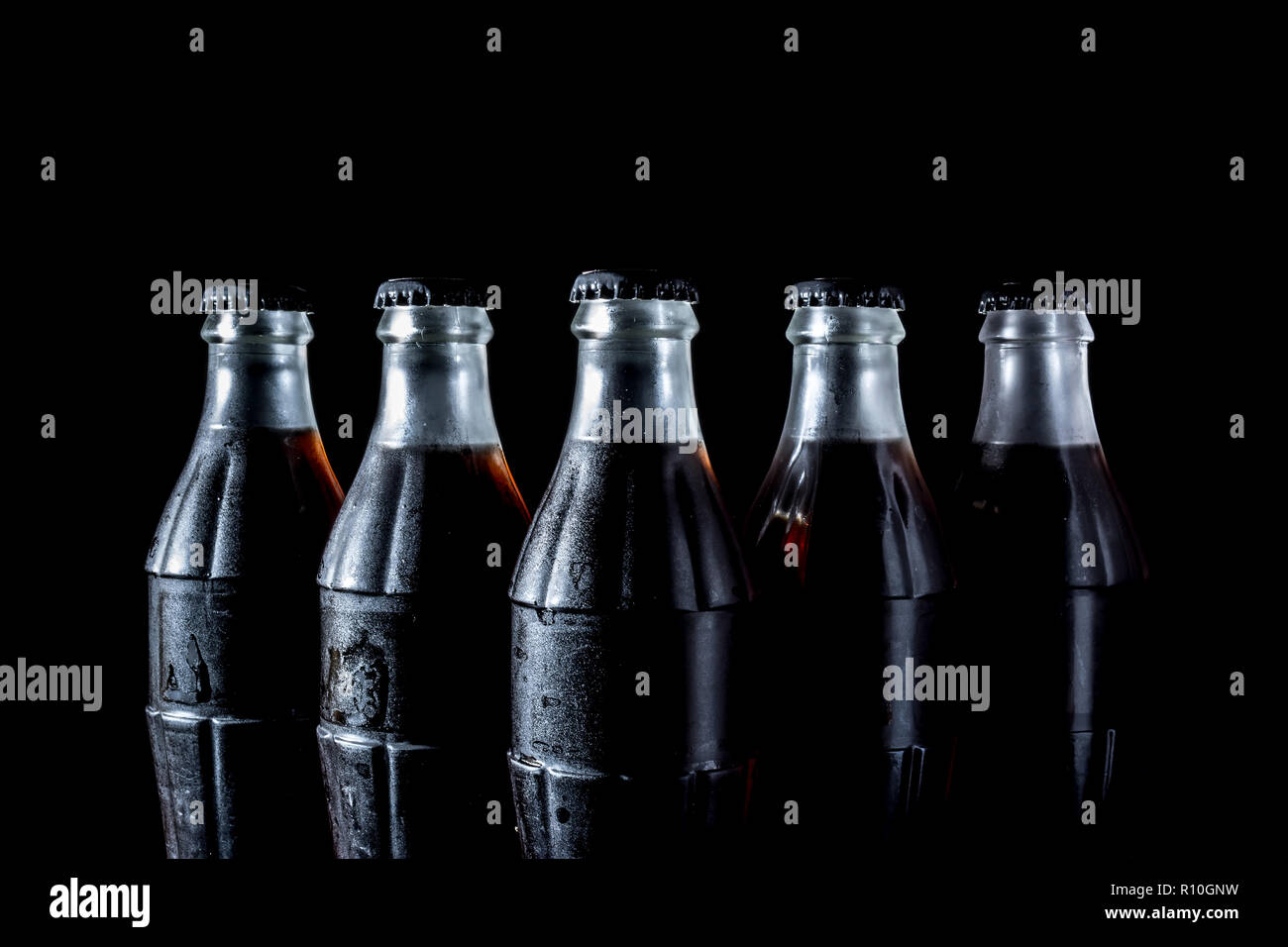 Soda glass bottles isolated on black background Stock Photo - Alamy