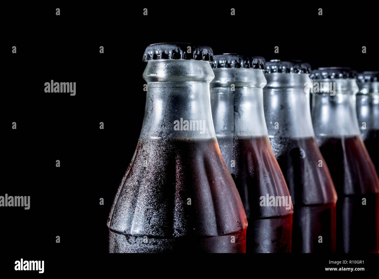 Soda glass bottles isolated on black background Stock Photo - Alamy