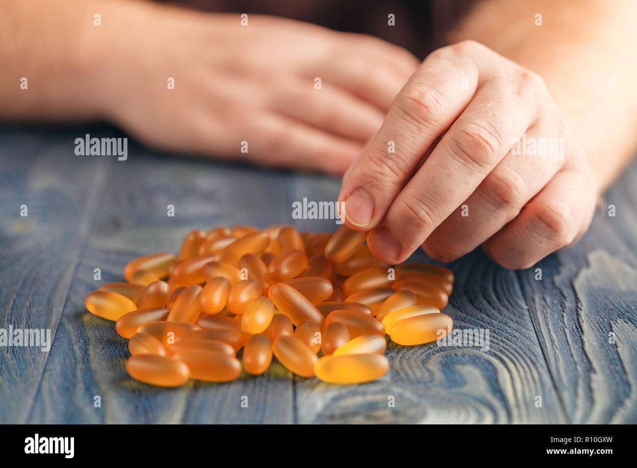 Pile of soft gel pills in people hands Stock Photo Alamy