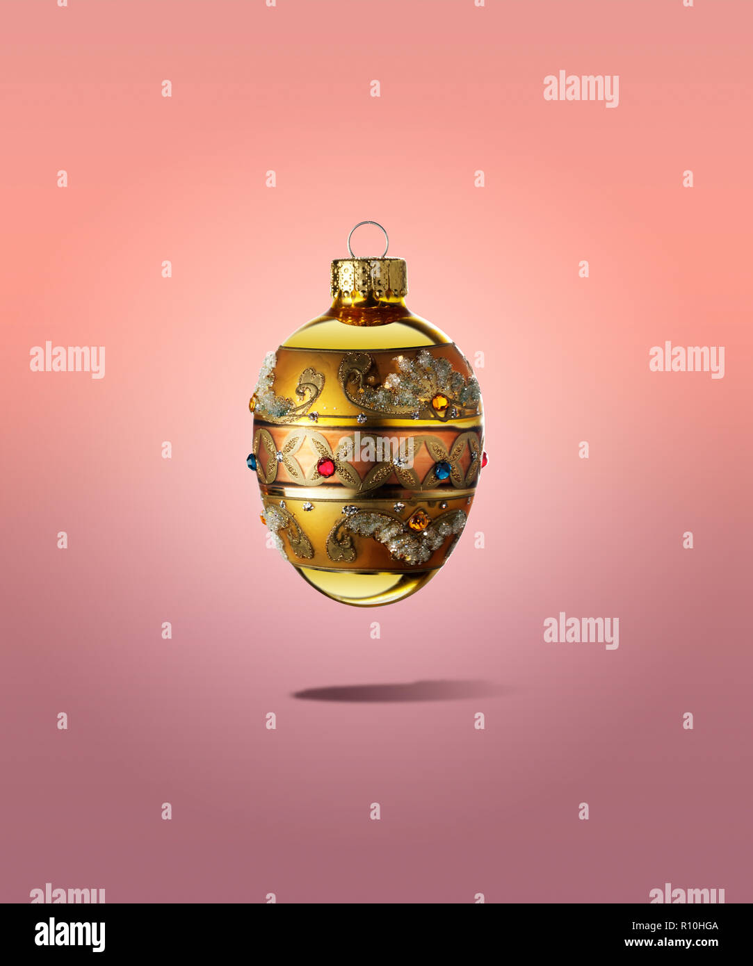 Beautiful Christmas bauble floating with shadow with pink background Stock Photo