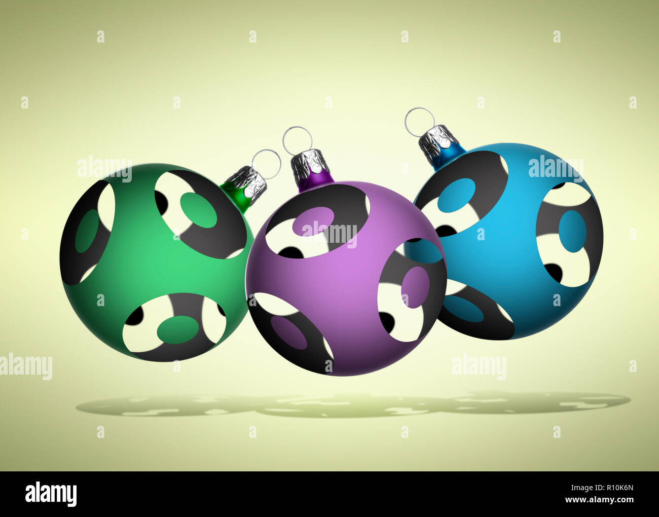 Close up of three Christmas baubles floating against a plain background Stock Photo