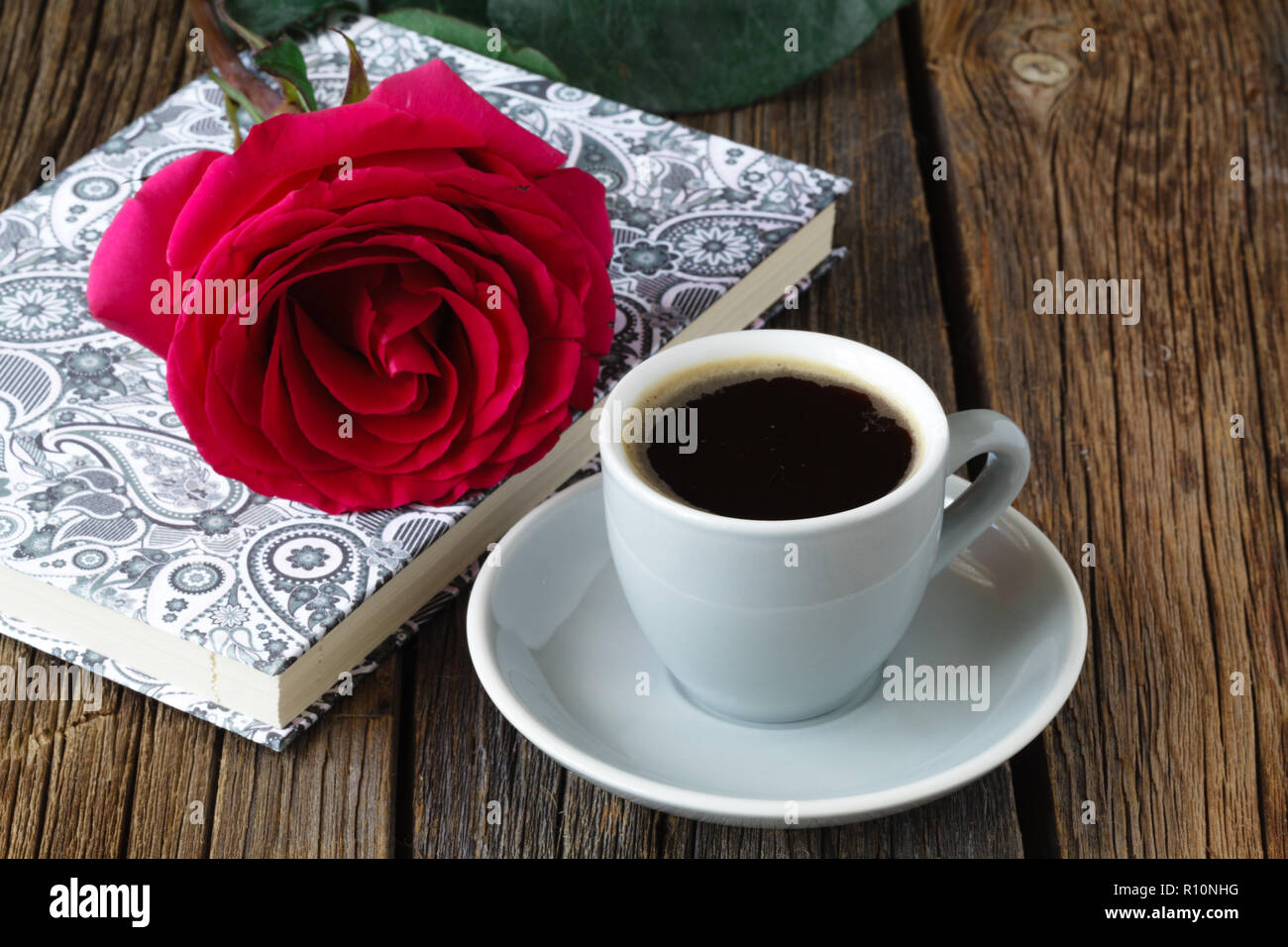 One red roses on the notebook Stock Photo - Alamy