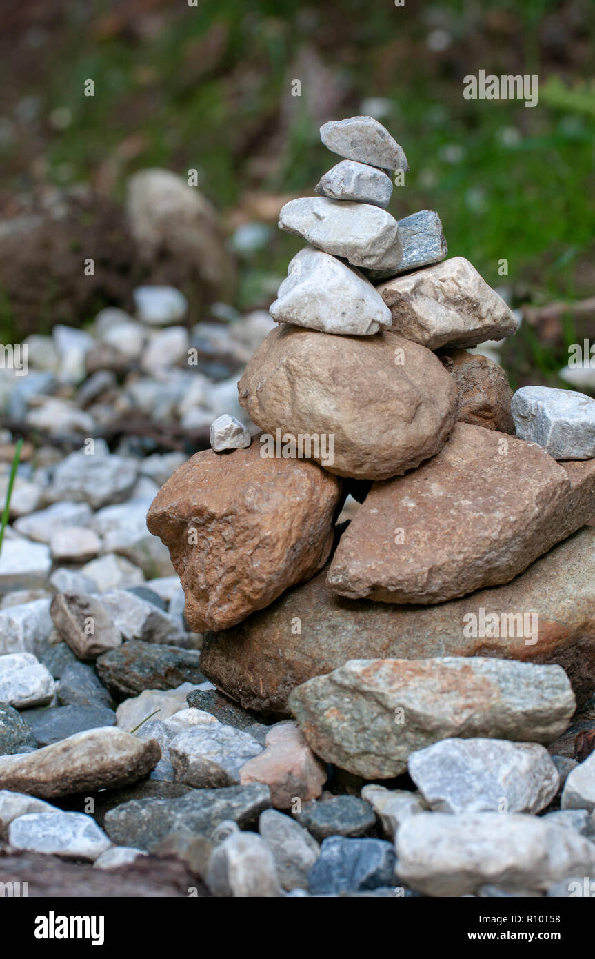 Stone markers left by hikers on the bank of the stream in Stubai, Tyrol, Austria Stock Photo