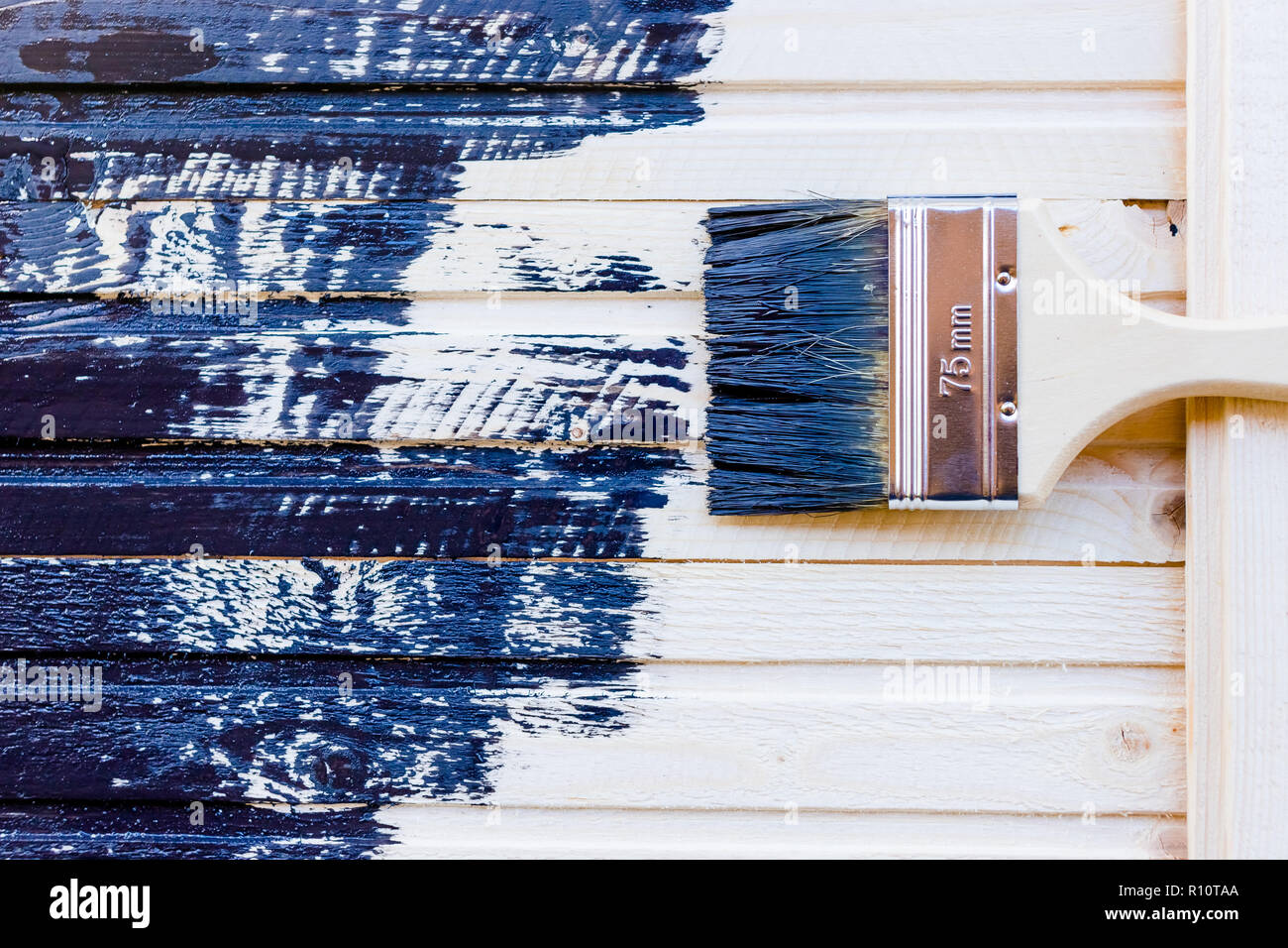 hand with paintbrush on wood.repair and restoration of the floor.Copy