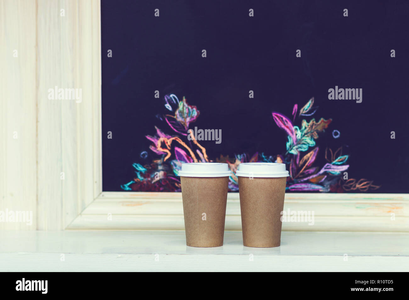 Two carton paper cups with cap at the bar with autumn pattern Stock ...