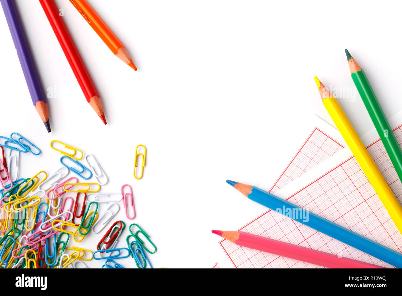Colored pencils and papper clip isolate on white Stock Photo