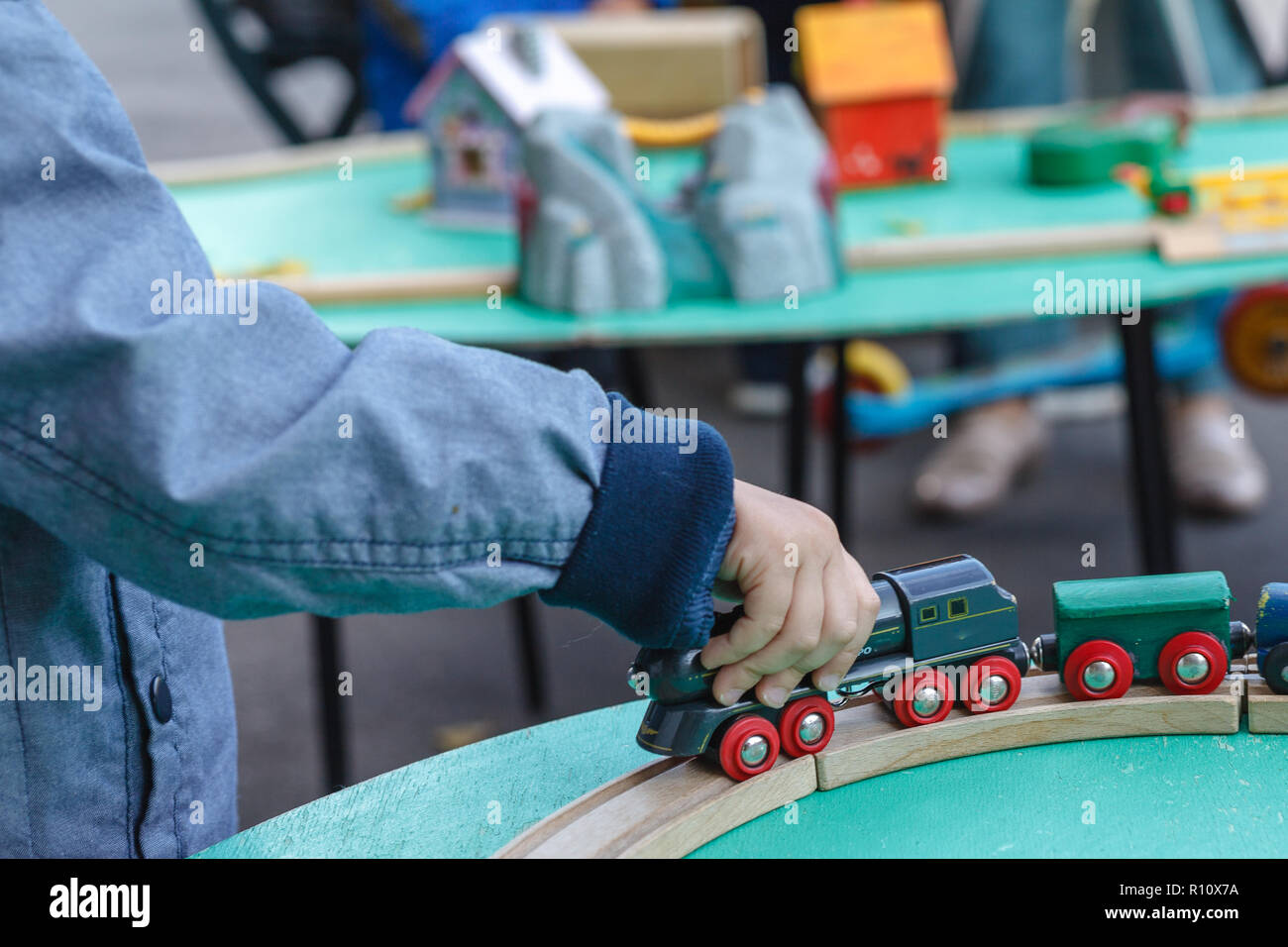 Autistic kid play alone with train toys Stock Photo - Alamy