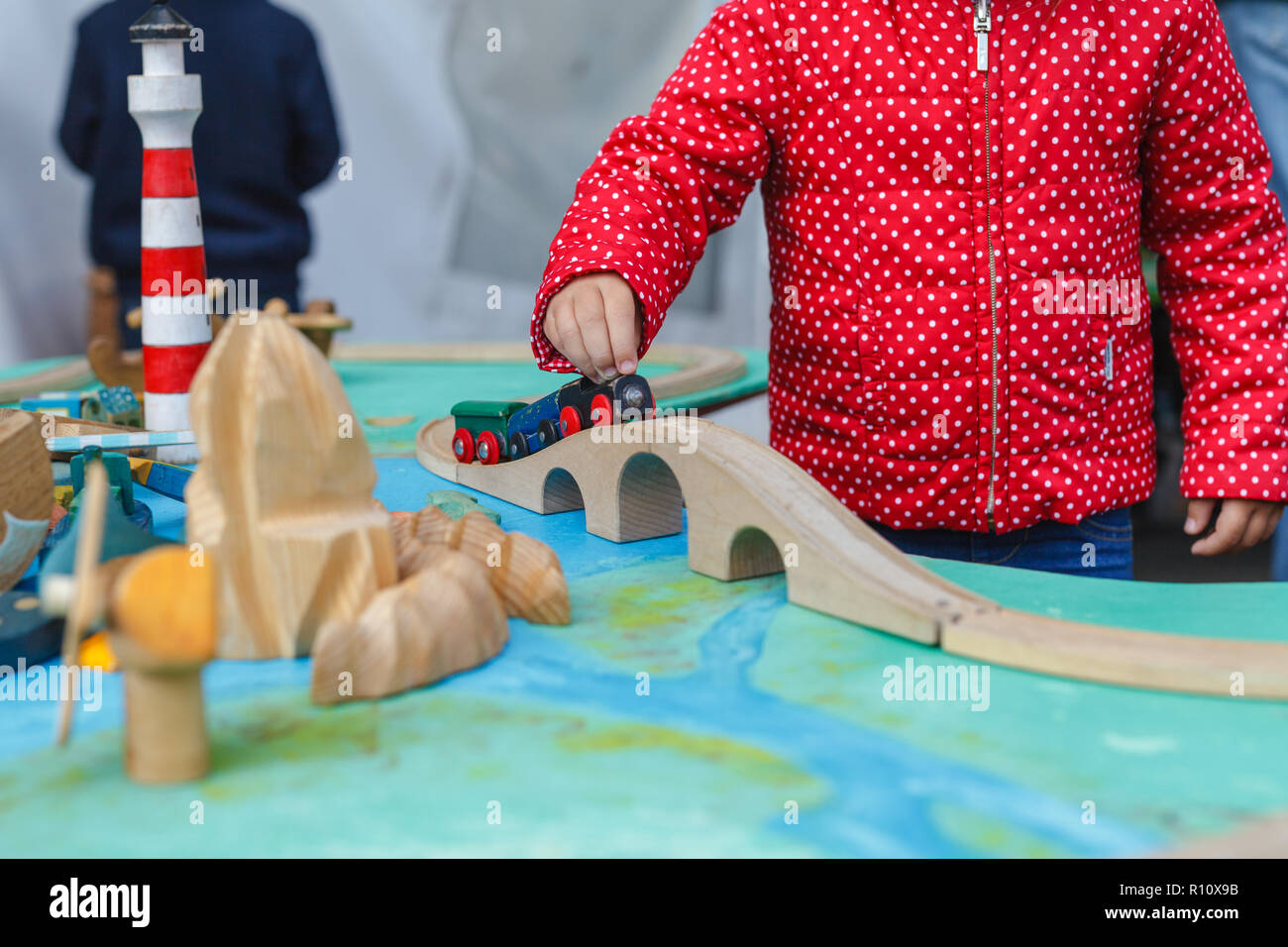 Little autistic boy playing with toy outdoor Stock Photo