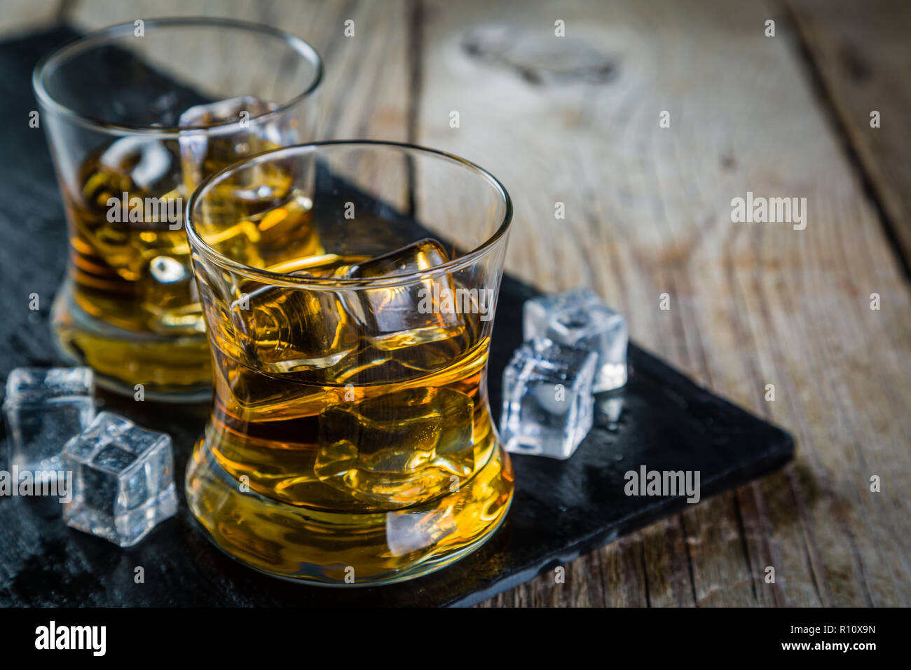 Whiskey with ice in glasses Stock Photo Alamy