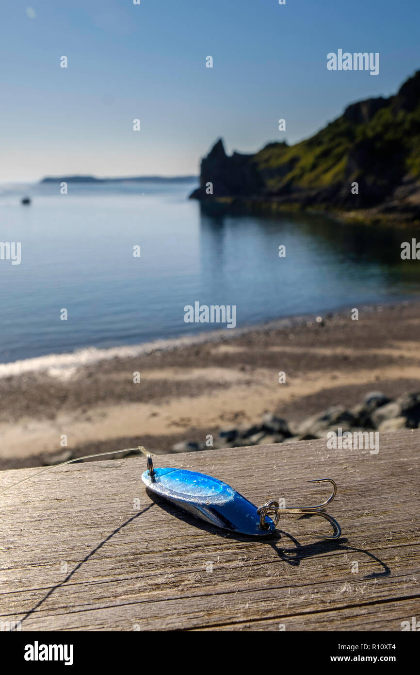 FISHING LURE SPINNER WITH BACKGROUND OF SEA Stock Photo