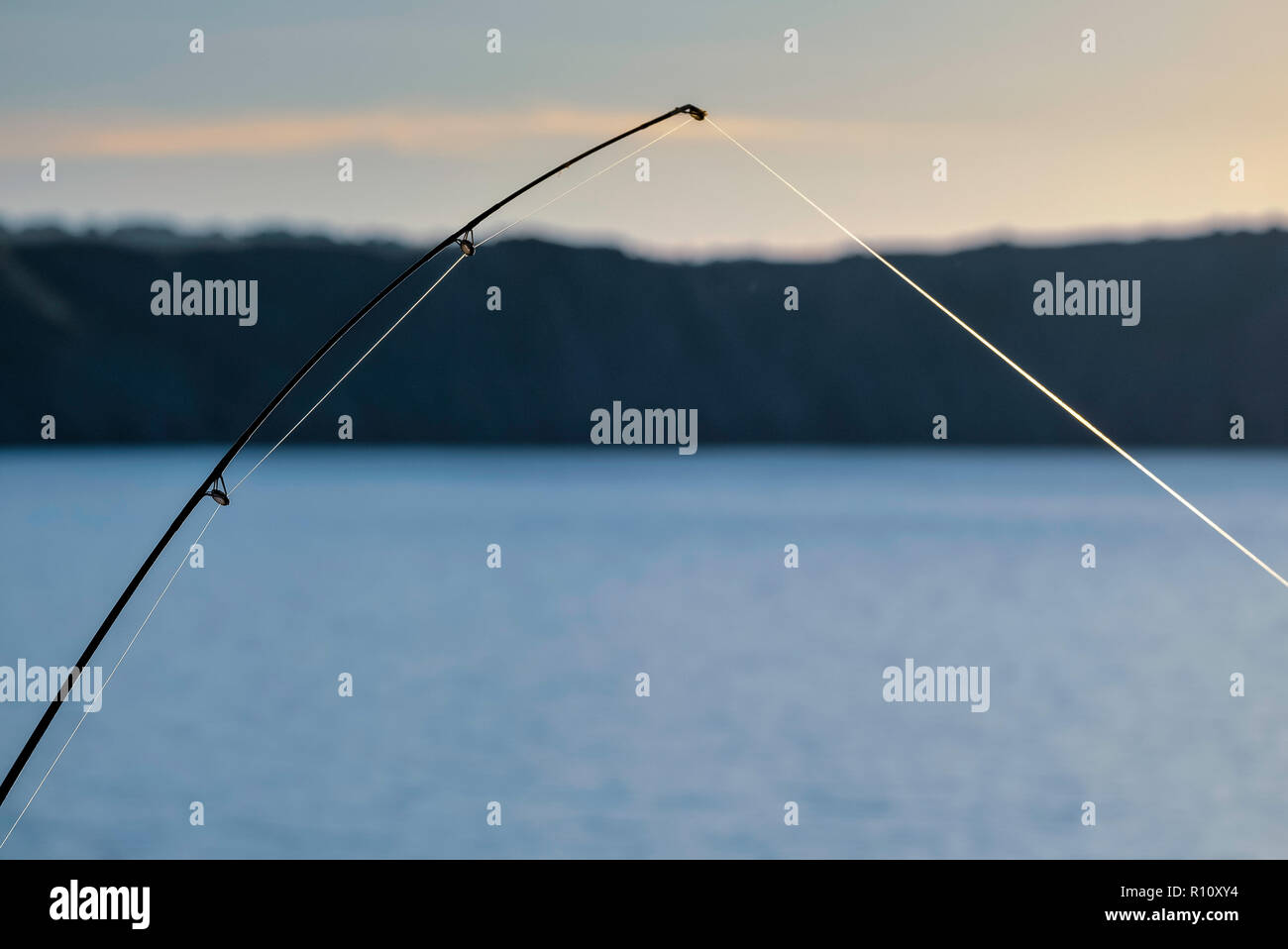 TIP OF FISHING ROD WITH TIGHT LINE. Stock Photo