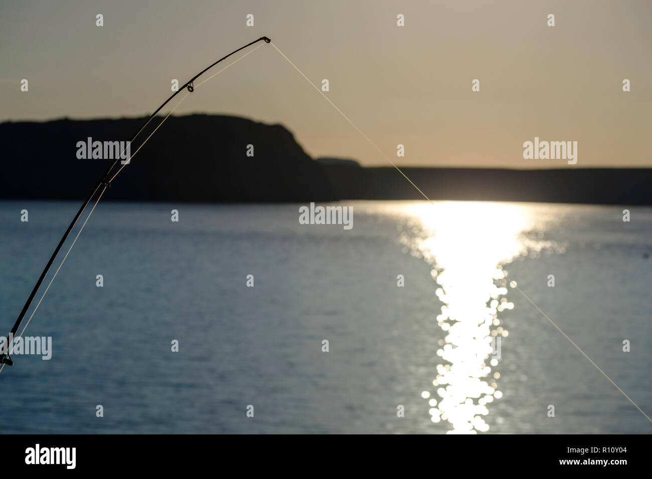 BENT SEA FISHING ROD WITH A  TIGHT LINE Stock Photo