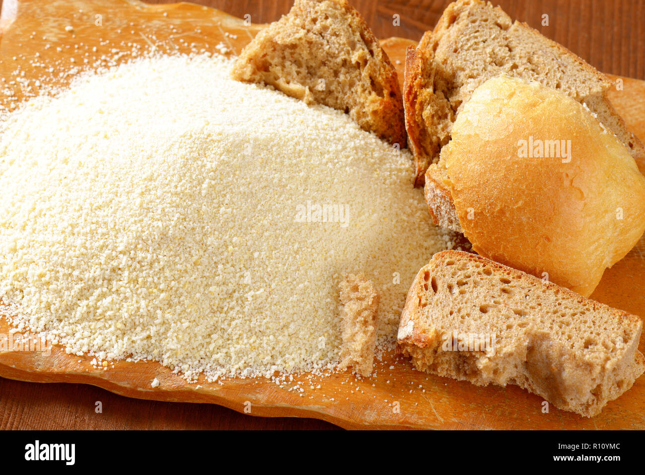 Pieces of stale bread and pile of finely ground bread crumbs Stock Photo