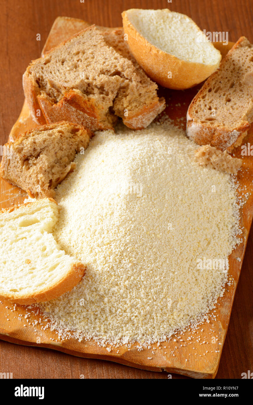 Pieces of stale bread and pile of finely ground bread crumbs Stock Photo