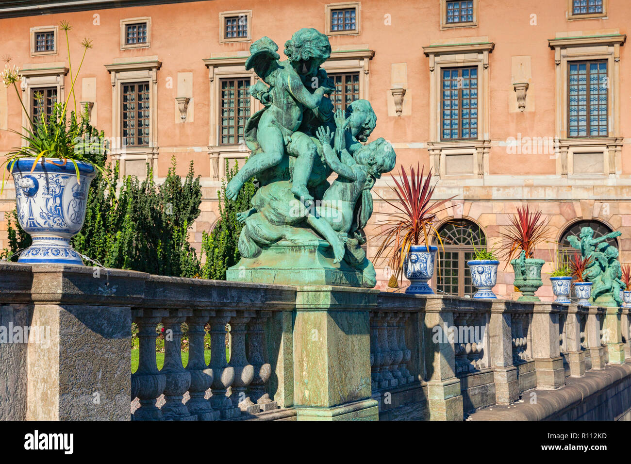 16 September 2018: Stockholm, Sweden - Detail of balustrade at Royal Palace, with urns full of plants and a cherub sculpture. Stock Photo