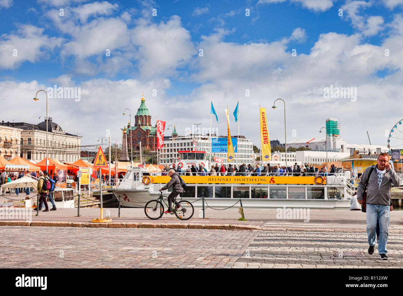 20 September 2018: Helsinki, Finland - The Helsinki waterfront, with crowds of tourists and a sightseeing boat. Stock Photo