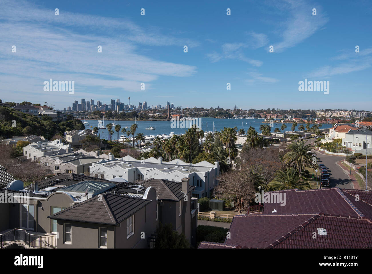 Looking across the rooftops of houses in the Sydney suburb of Woolwich to Sydney Harbour and the historic ship yards of Cockatoo Island Stock Photo