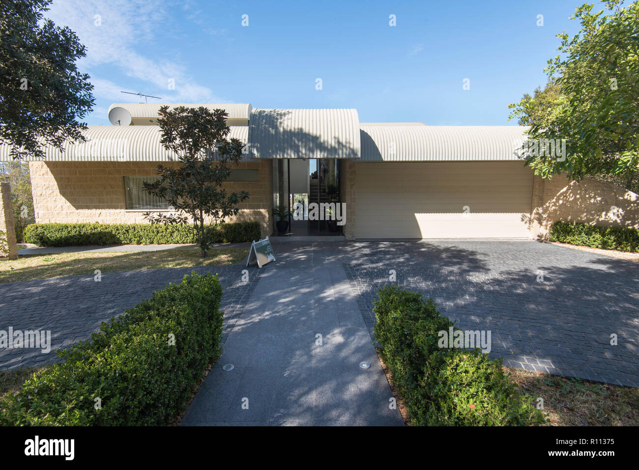 A contemporary Harry Seidler designed home in Hunters Hill, Sydney Australia with a curvilinear steel roof Stock Photo