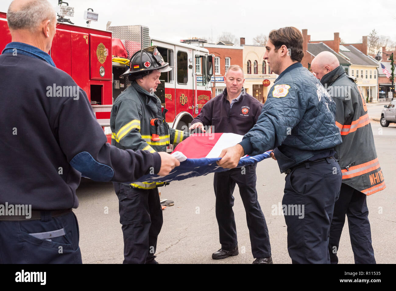 Firefighters from Bedford and Concord fire departments folding the flag