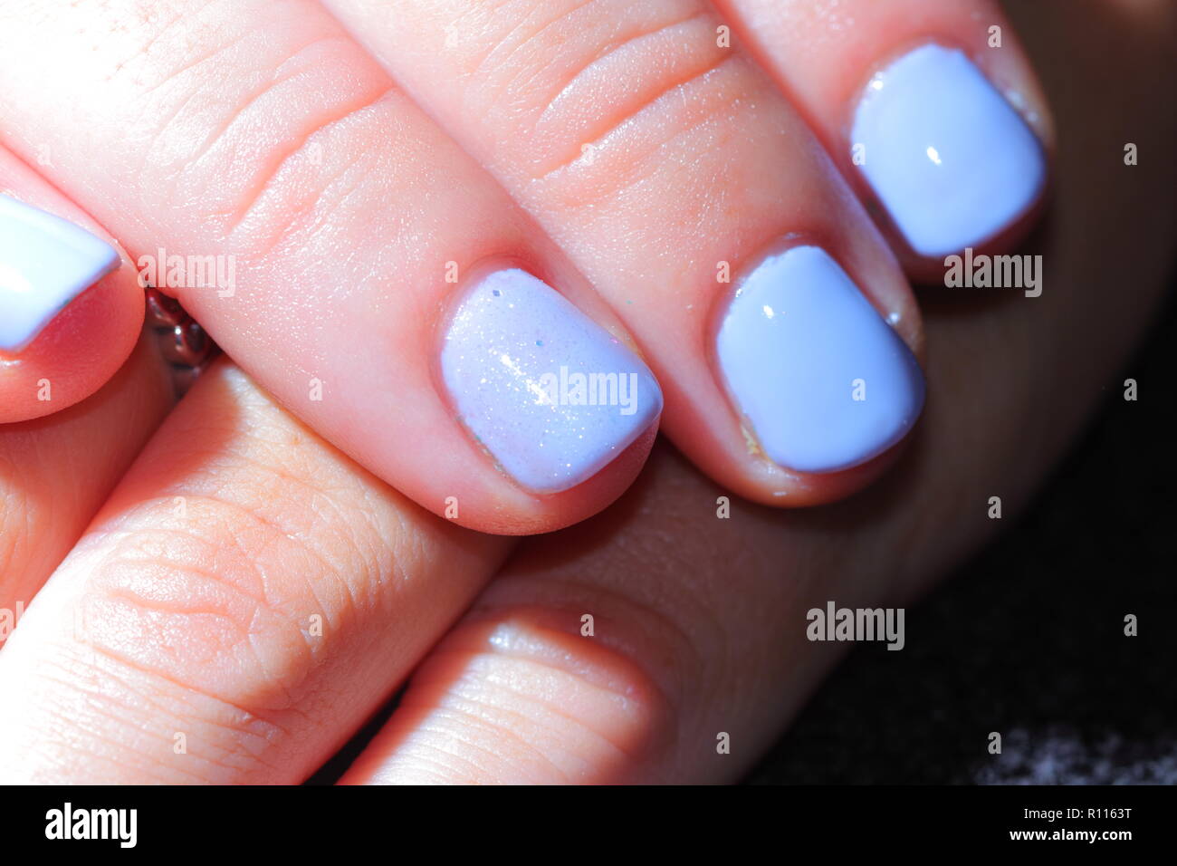 Lilac coloured finger nails Stock Photo