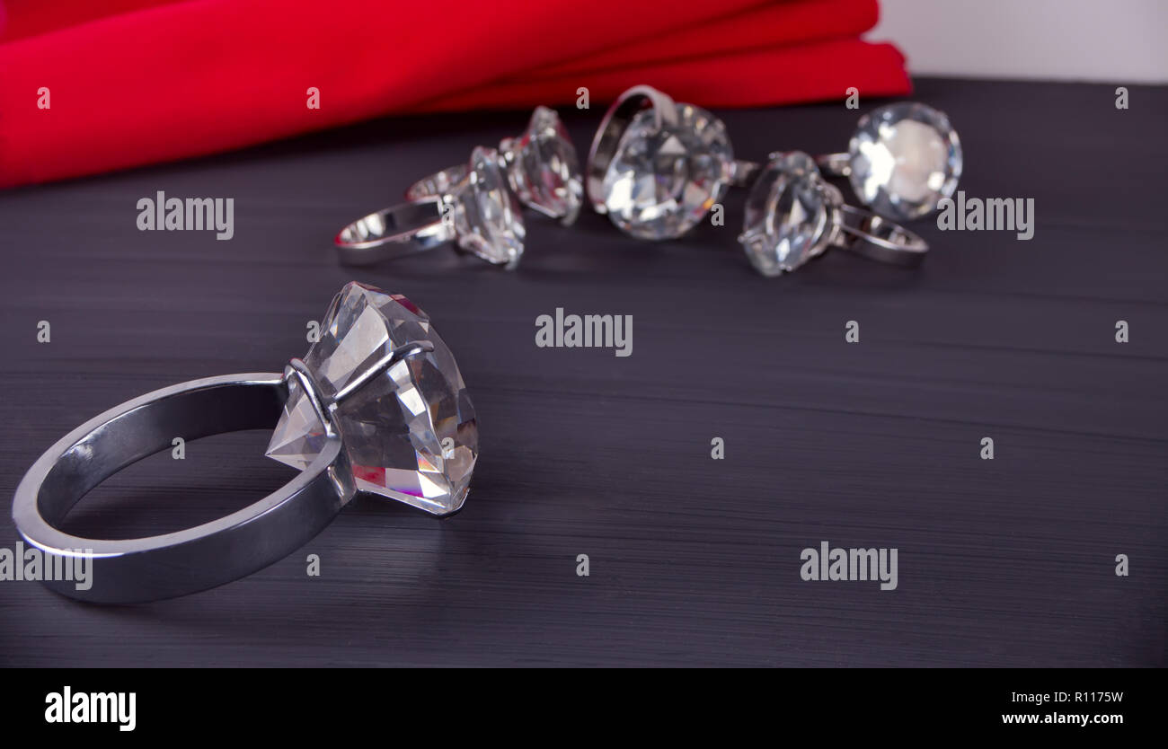 Premium Photo | Jewelry ring witht big diamond on dark coal and black sand  backg