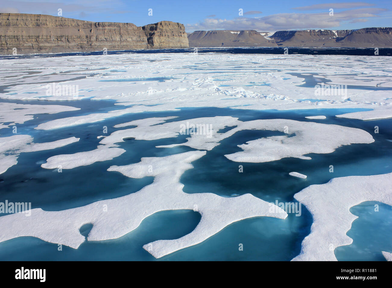 Frozen Landscape of Lancaster Sound With Devon Island in Background, Arctic Canada as seen from CCGS Amundsen Stock Photo