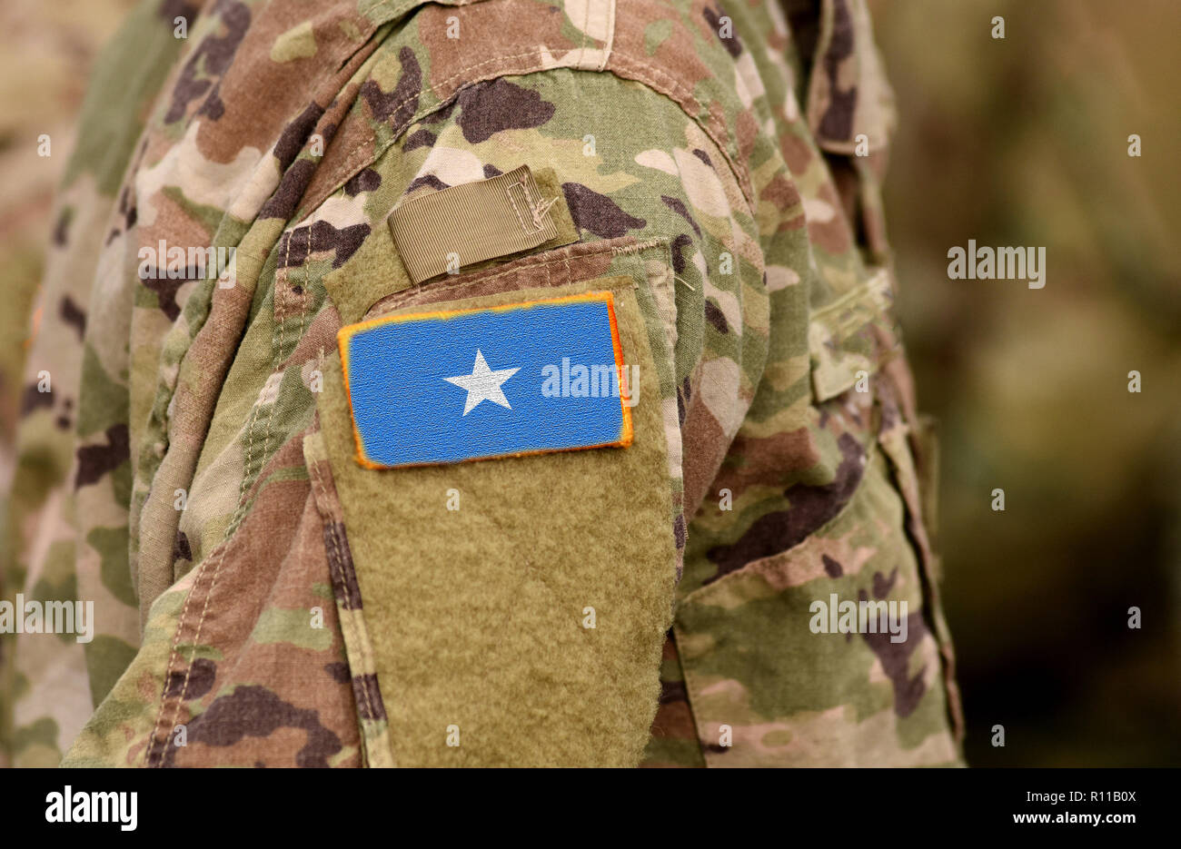 Somalia  flag on soldiers arm. Somali army (collage) Stock Photo