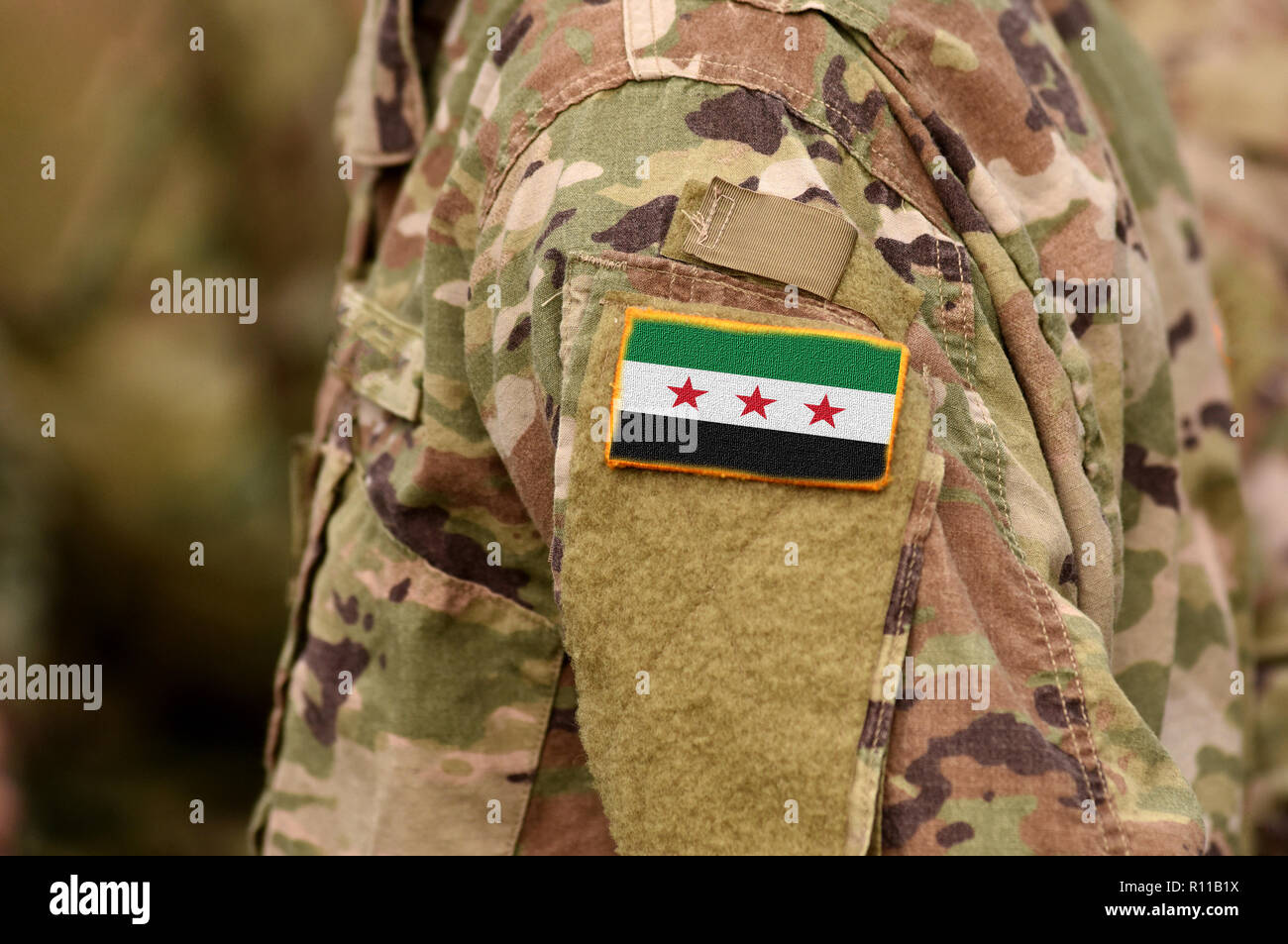 Soldiers arm with Flag used by the Syrian Opposition and Syrian Revolutionary and Opposition Forces Stock Photo