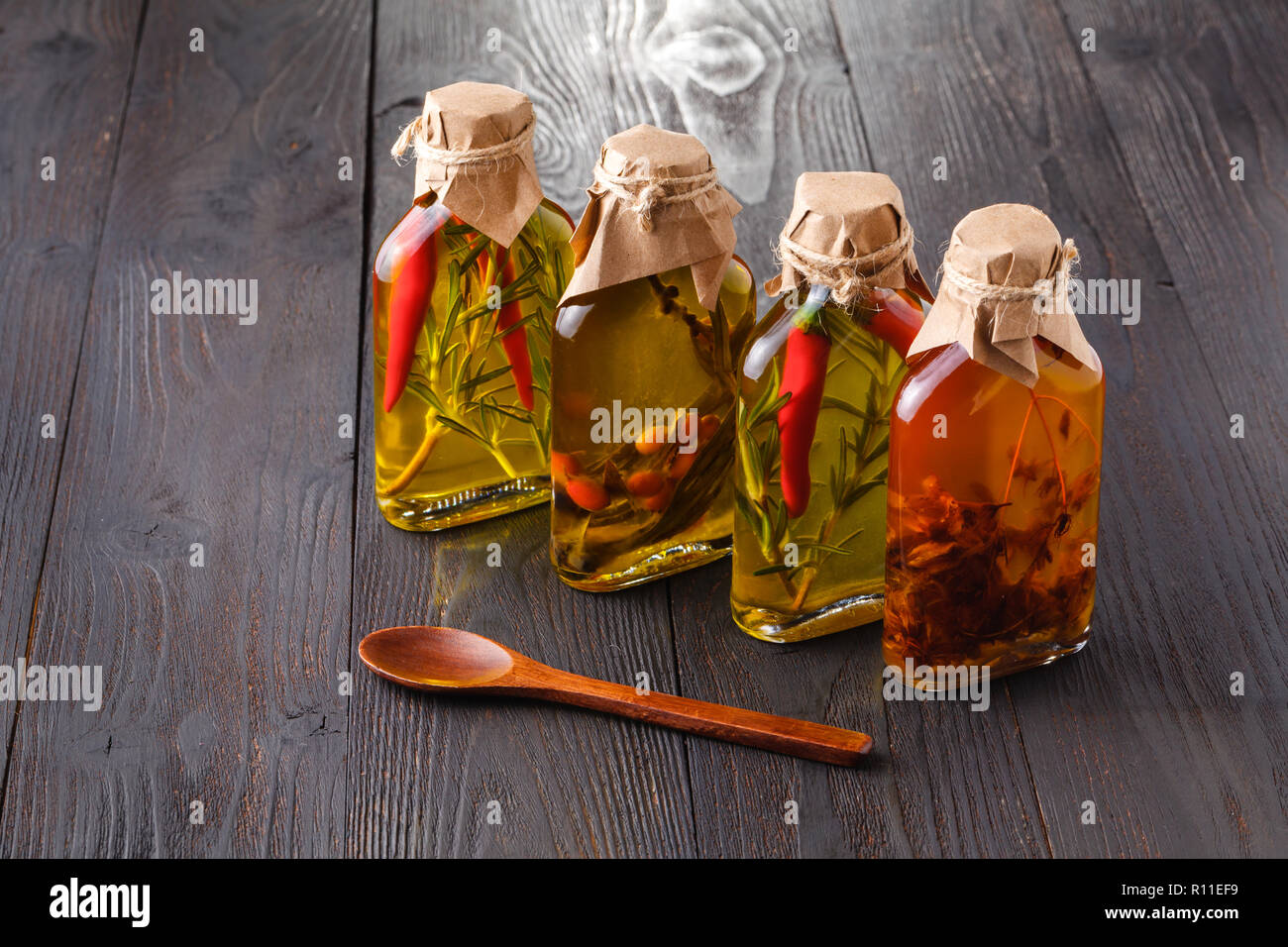 Bottles of extra virgin olive oil with aromatic herbs Stock Photo - Alamy