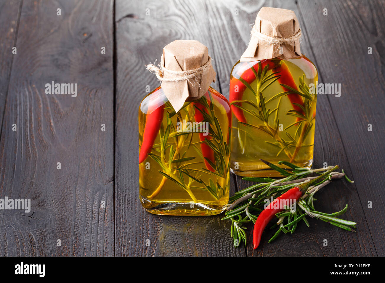 Bottles of extra virgin olive oil with aromatic herbs Stock Photo - Alamy