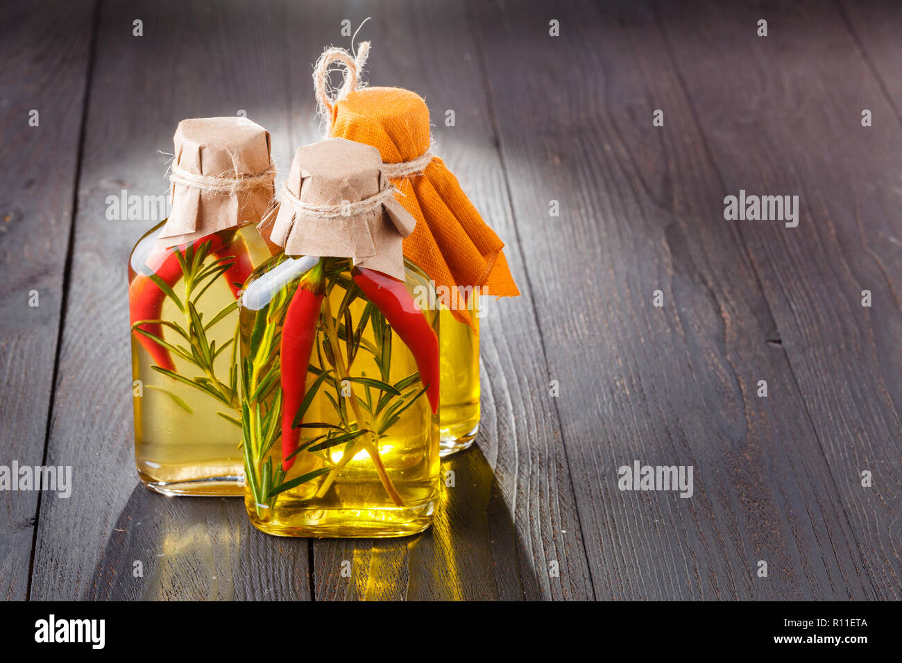 Bottles of extra virgin olive oil with aromatic herbs Stock Photo - Alamy