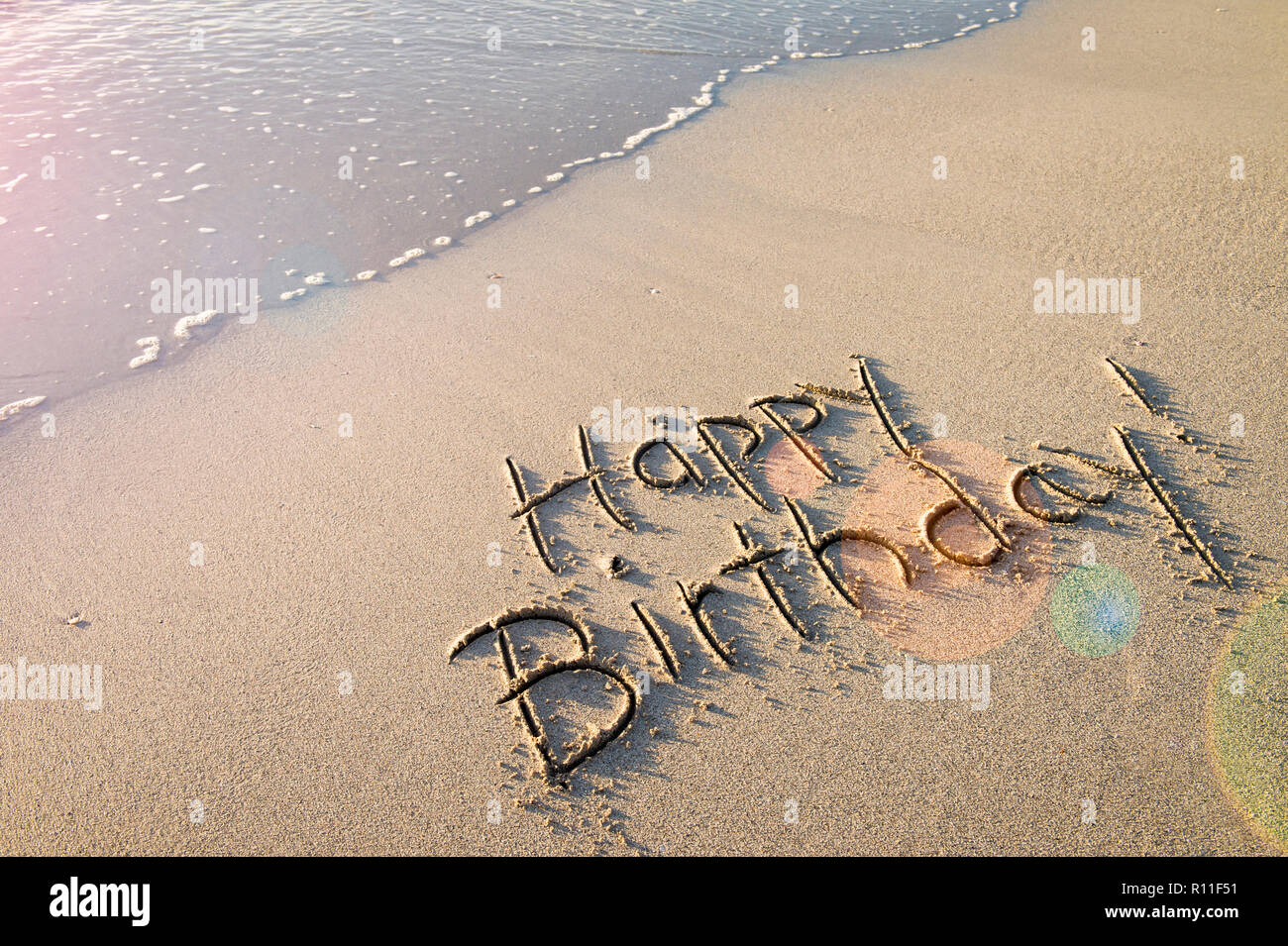 Happy Birthday Message Handwritten In Smooth Sand With Festive Lens Flare On The Shore Of An Empty Beach Stock Photo Alamy Happy Birthday Message Handwritten In Smooth Sand With Festive Lens Flare On The Shore Of An Empty Beach Stock Photo Alamy