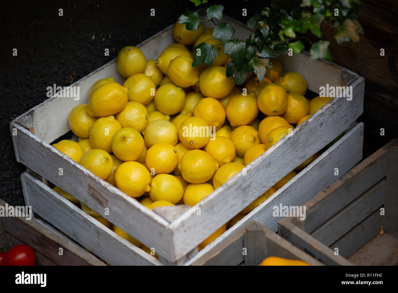 A crate of lemons on sale at a shop Stock Photo Alamy