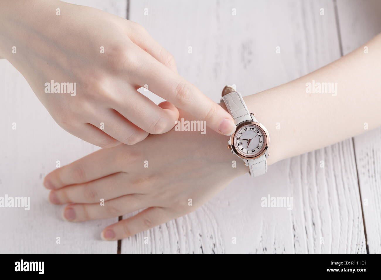 Checking time, female wrist watch on hand Stock Photo