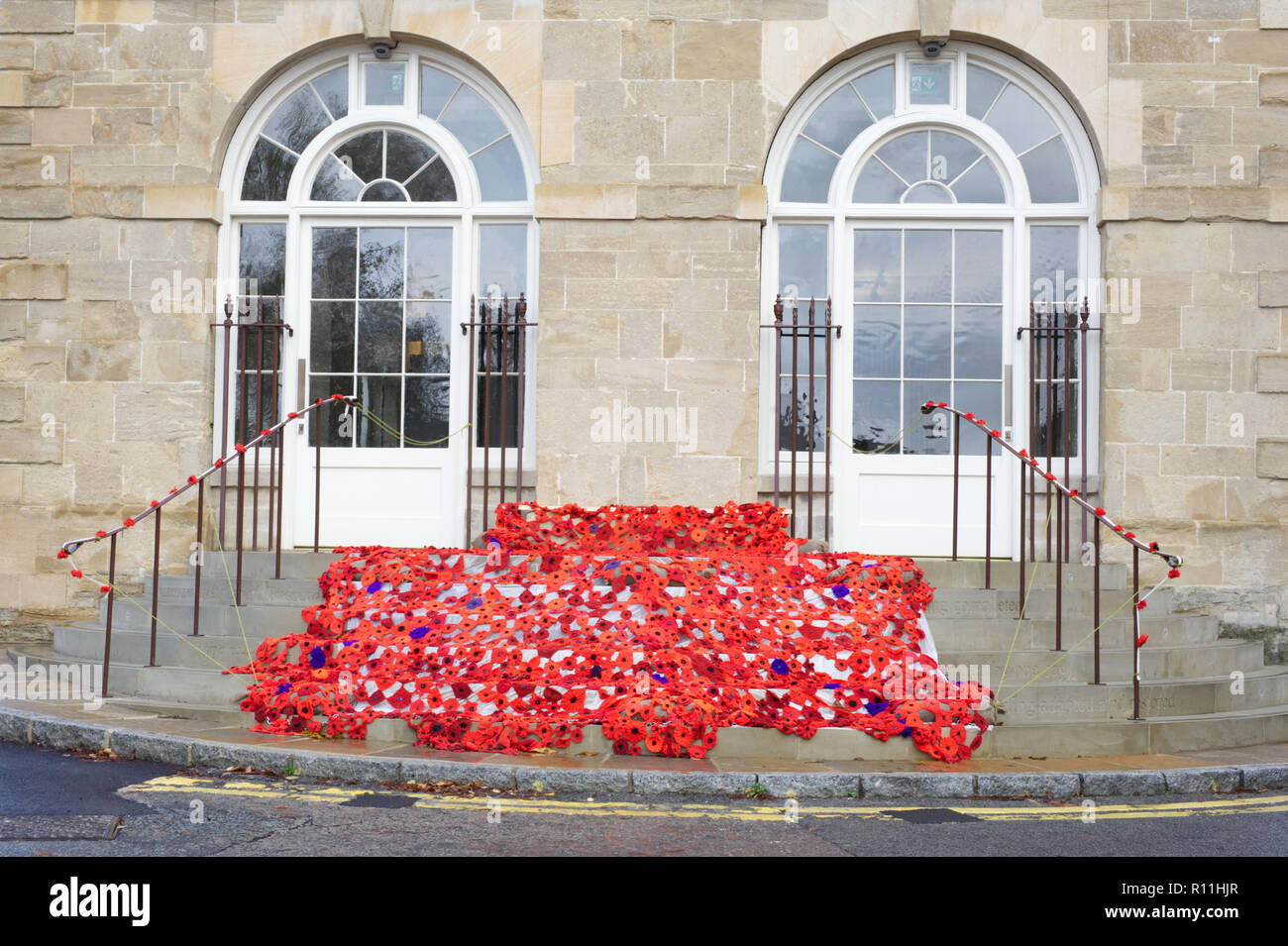 Brackley Town Hall adorned with knitted and crocheted poppies to mark the Armistice centenary, 2018. Stock Photo